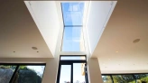 Eaves skylight above doorway letting natural light shine in